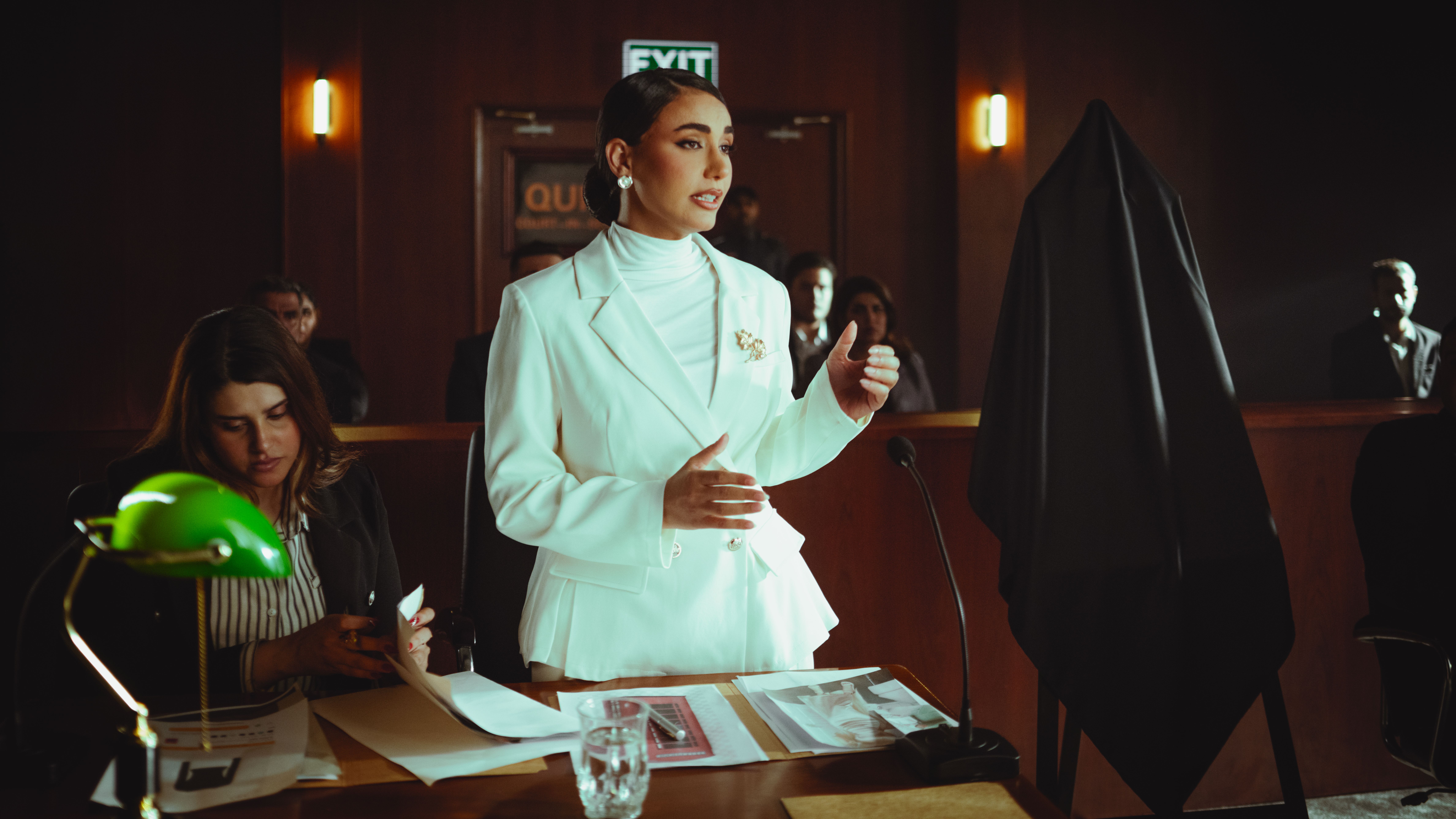 Confident attorney presenting a case before a courtroom, illustrating the trial phase of litigation