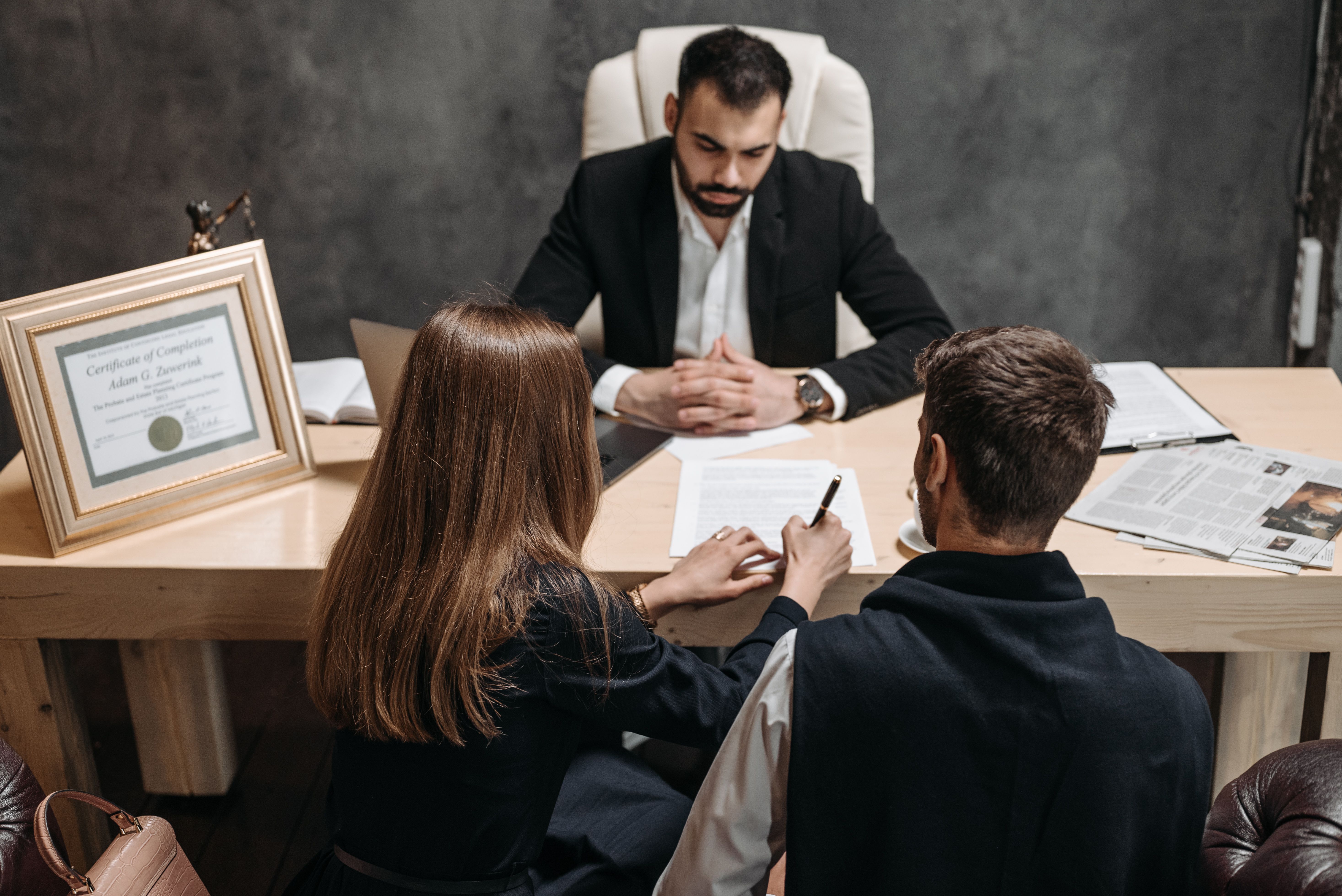 Legal team discussing case documents in an office during pretrial preparation