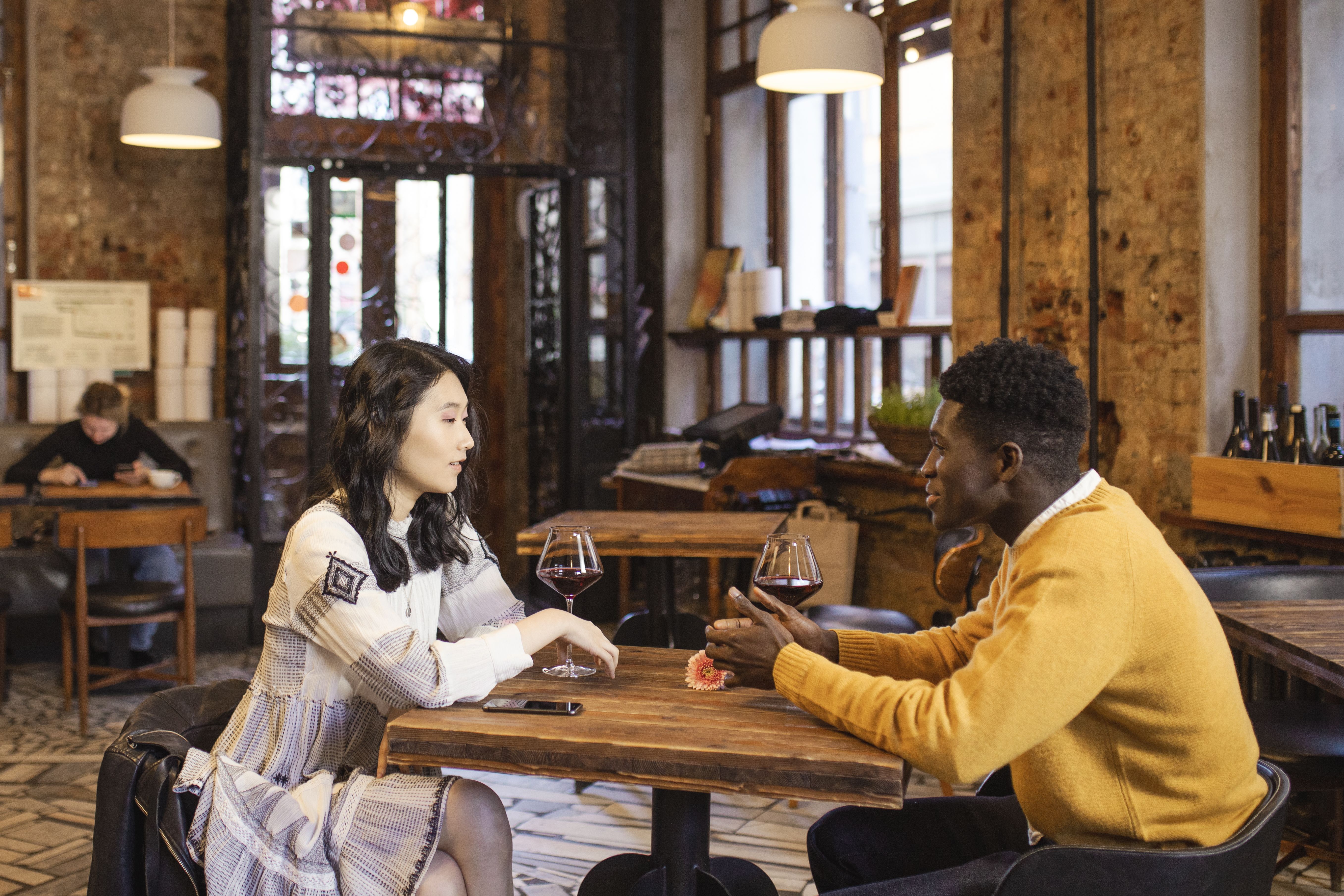 Interracial couple enjoying a relaxed date and conversation at a cafe
