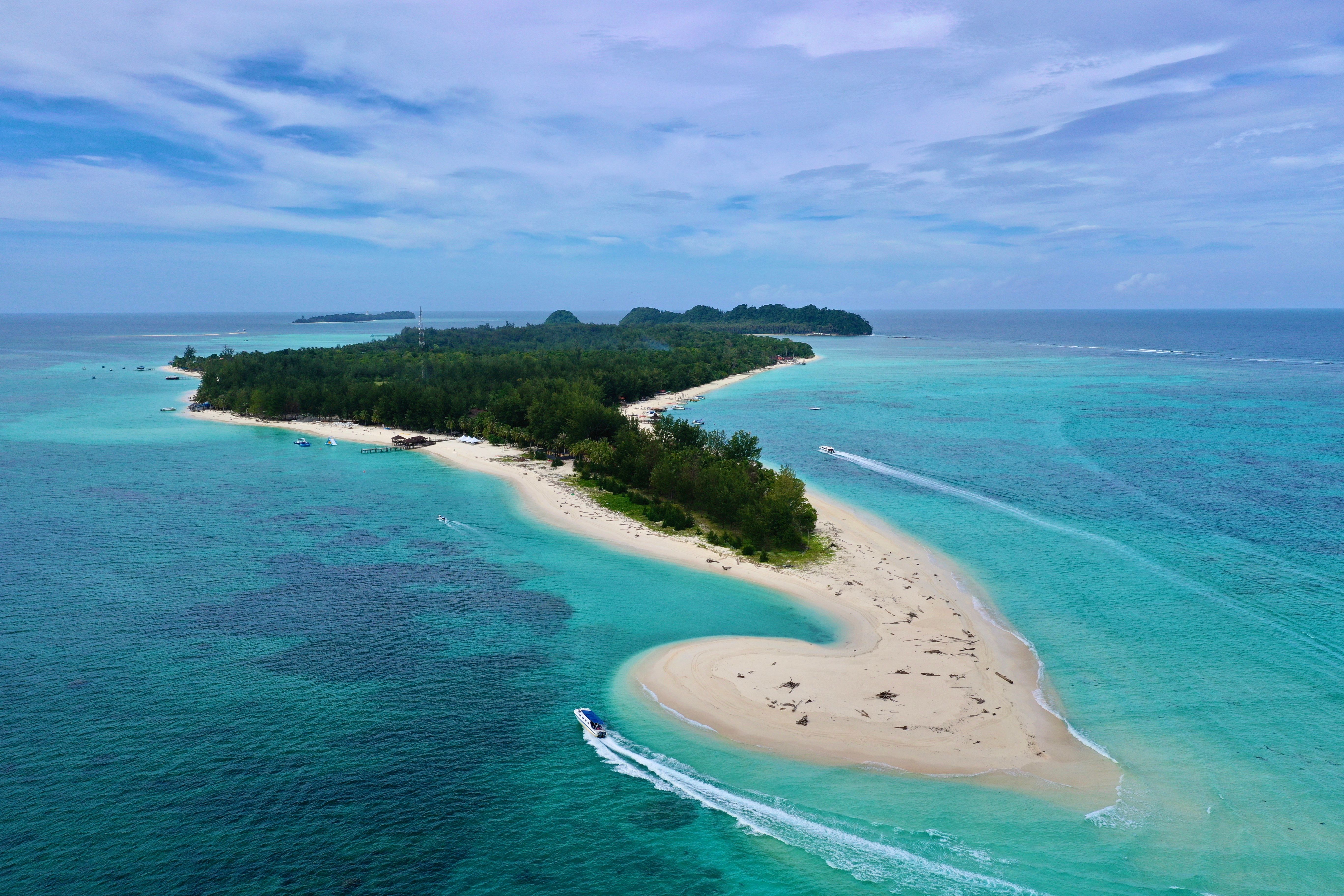 Aerial view of turquoise waters and sandy coast near a Malaysian island